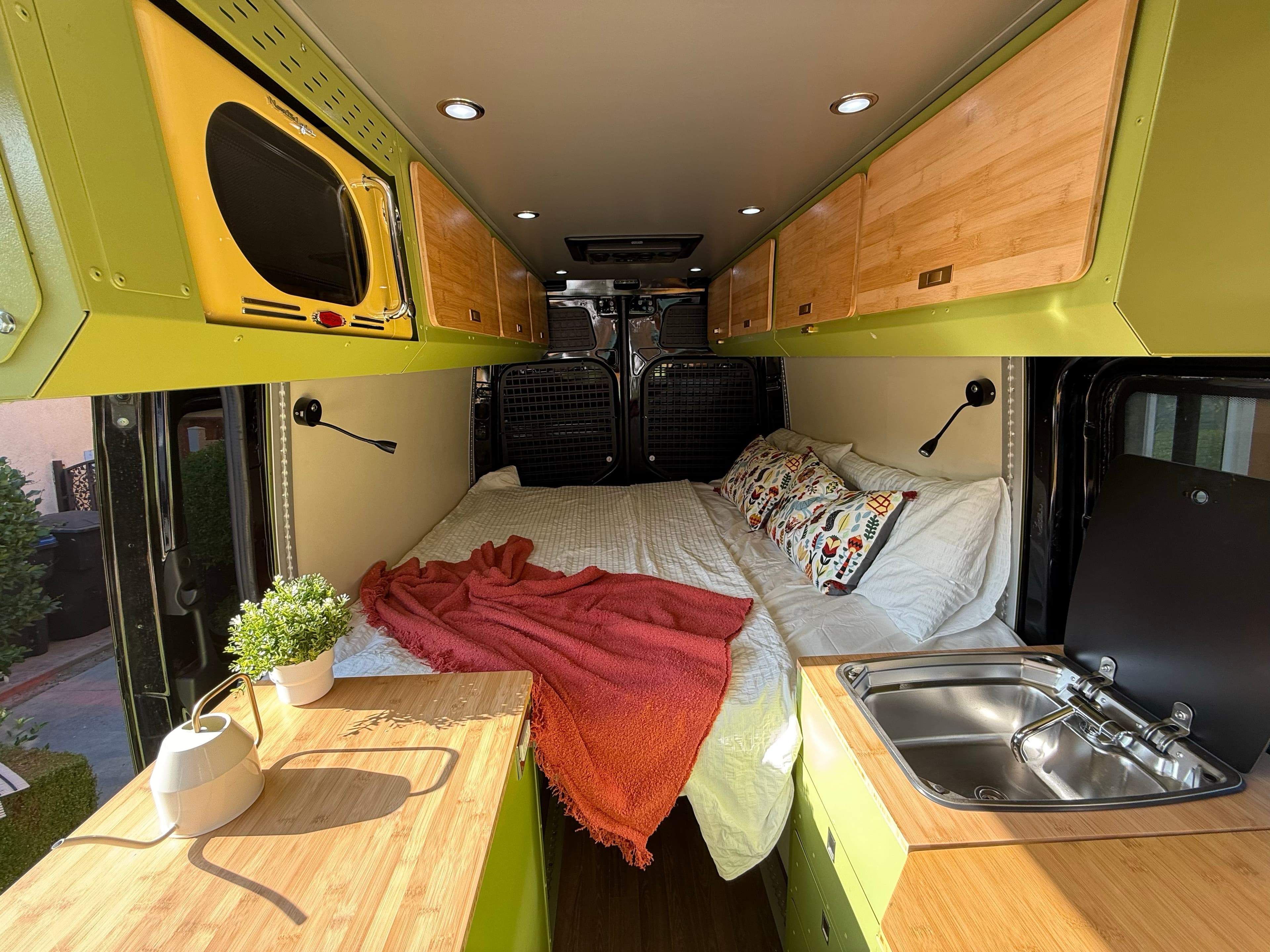 Deluxe Build interior with bed, kitchen and wood cabinets